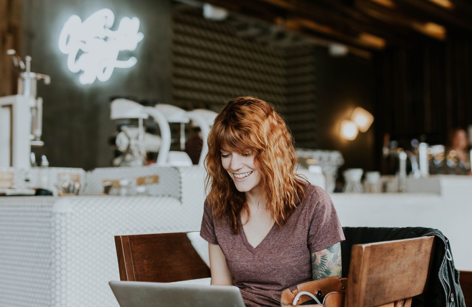 Girl looking at Laptop screen & smiling