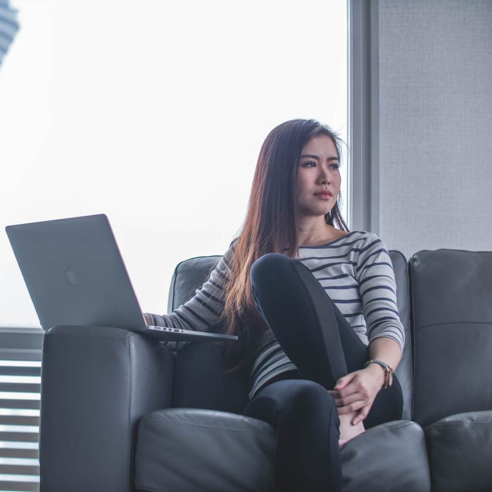 Women sitting on the couch with laptop